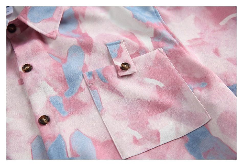Close-up of the shirt front showing brown buttons and a large buttoned chest pocket.