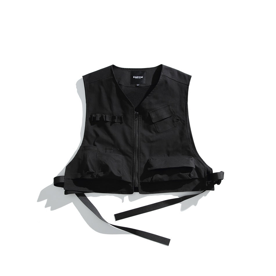Black sleeveless utility vest flat lay with front zipper, multiple pockets and black side straps
