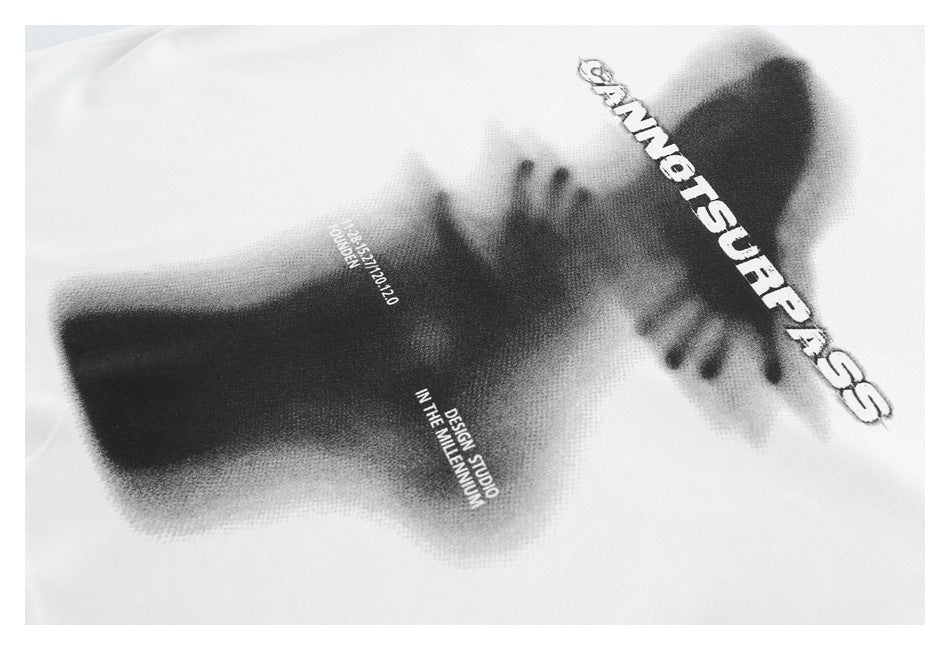 Close-up of a white shirt with a black-and-white graphic print and English lettering.