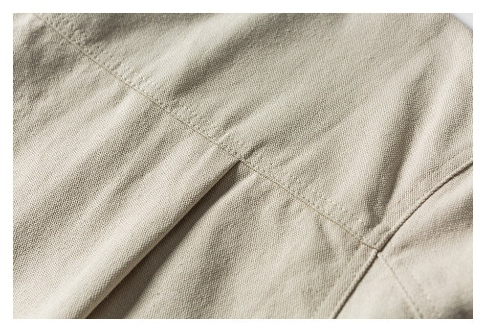 Close-up of beige garment stitching and a folded seam.
