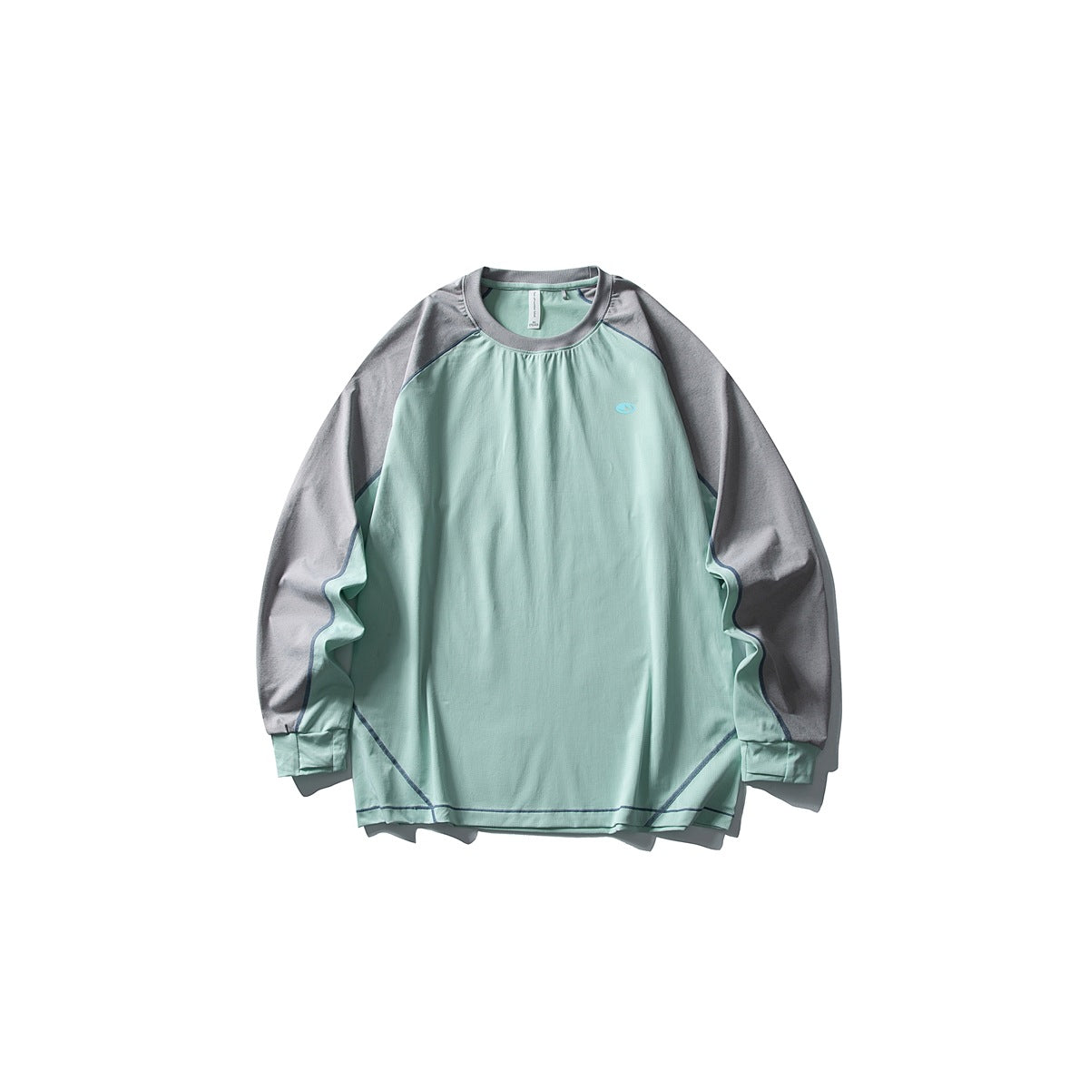 Front of a mint green long-sleeve raglan tee with gray sleeves, blue contrast stitching and a small chest logo