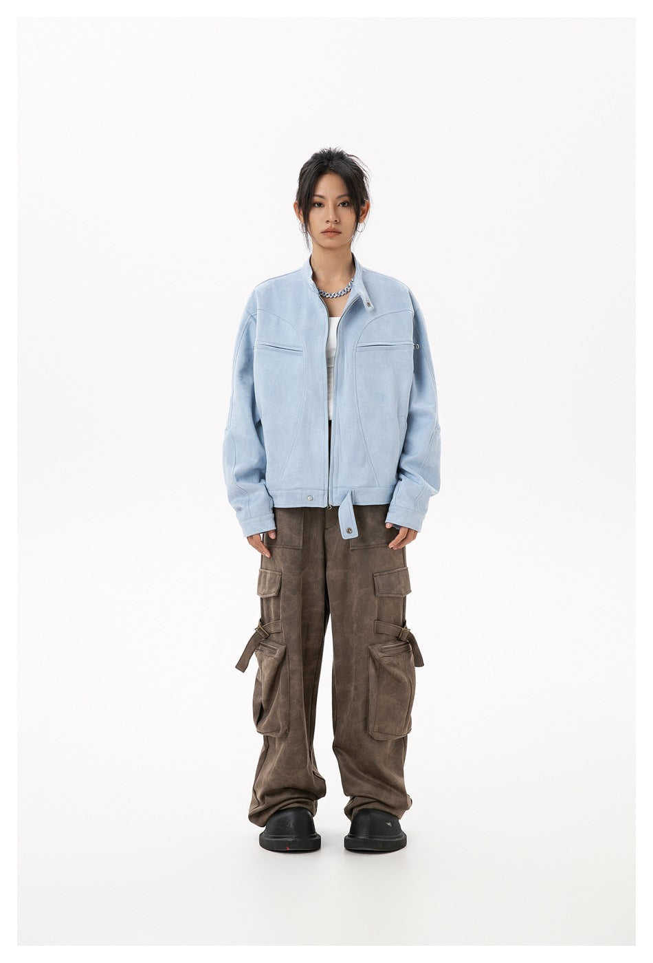 Model wearing a light blue stand-collar zip jacket over a white top with brown cargo pants, front view