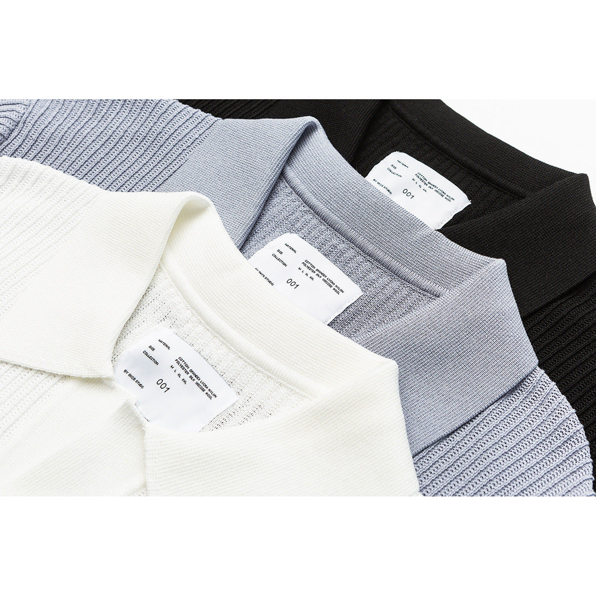 Close-up of white, pale blue, and black knit polo collars with sewn-in neck labels.