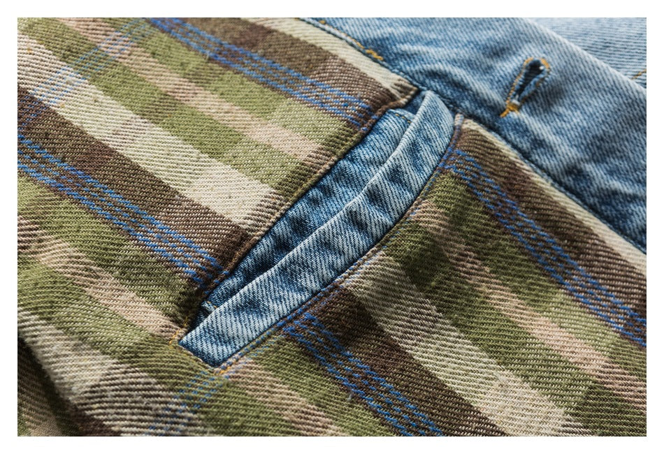 Close-up of a denim pocket set into brown, olive, cream and blue plaid fabric.