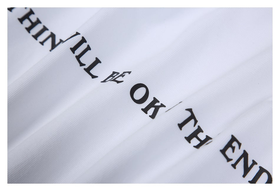 Close-up of black English lettering on white garment fabric.
