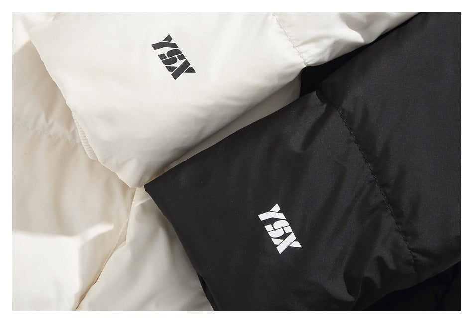 Close-up of black and cream jacket sleeves with small contrasting printed logos.