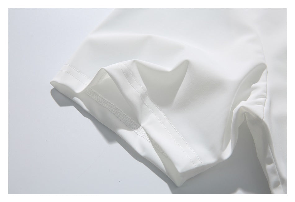 Close-up of a folded white garment edge showing its stitching and finished seam.