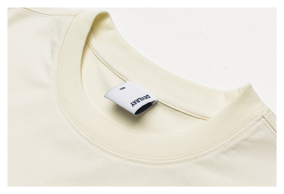 Ivory sweatshirt crewneck collar and sewn-in label, shown in a cropped product detail.