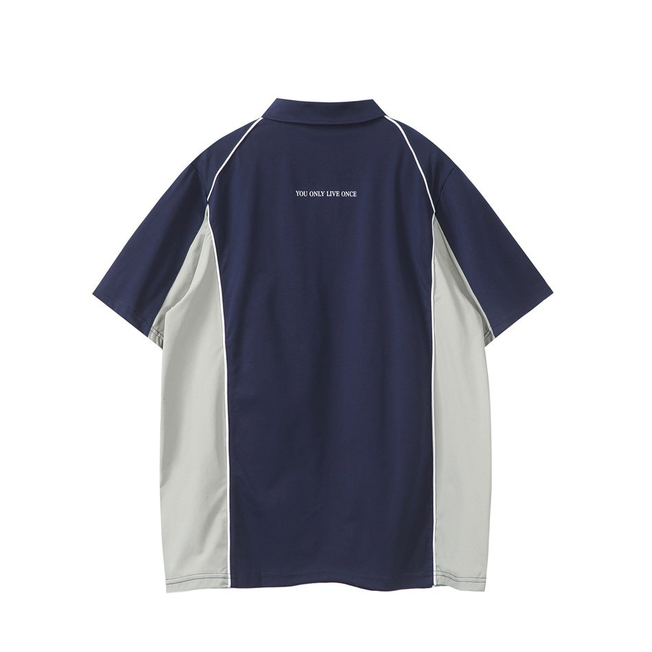 Back view of a navy polo shirt with light gray side panels, white piping, and small text at the upper back.