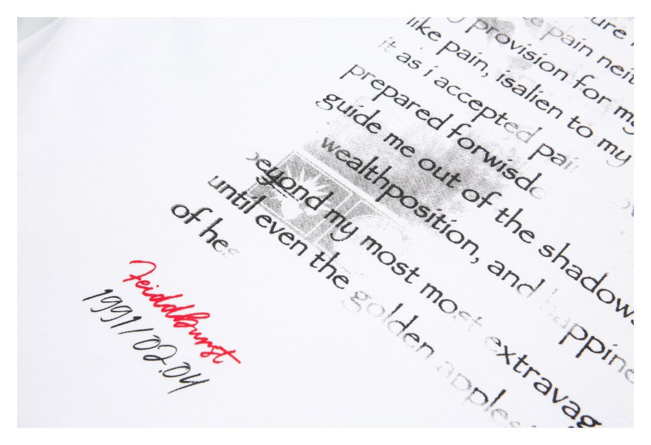 Close-up of distressed black and gray English lettering with a red handwritten-style mark on white fabric.