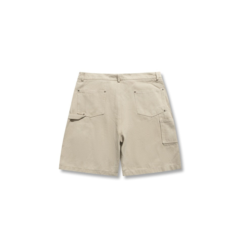 Back view of light beige utility shorts with two rear pockets and a side cargo pocket.