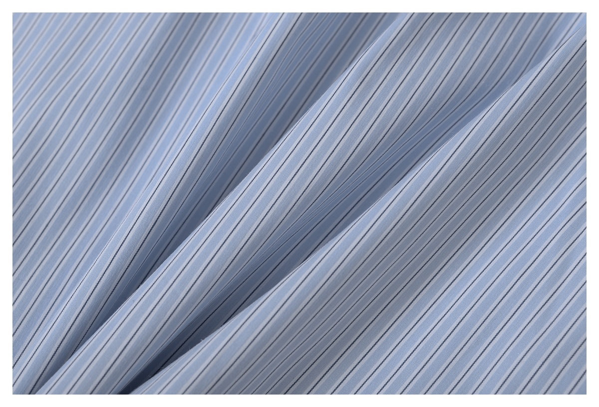 Close-up of light blue fabric with fine dark and white stripes draped into soft folds.