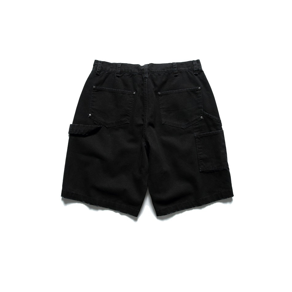 Black carpenter-style shorts, flat lay back view with two rivet patch pockets and a side utility pocket