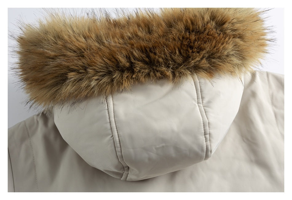 Close-up of an ivory coat hood edged with thick brown faux-fur trim.