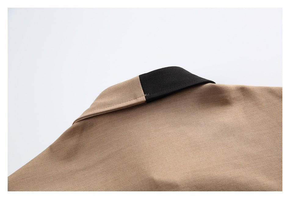 Close-up of a tan shirt collar with a black contrasting section.