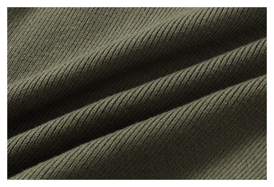 Close-up showing the olive-gray garment's fine ribbed knit texture.