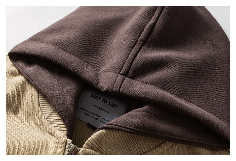 Close-up of a dark brown hood and sewn-in label above the beige jacket collar.