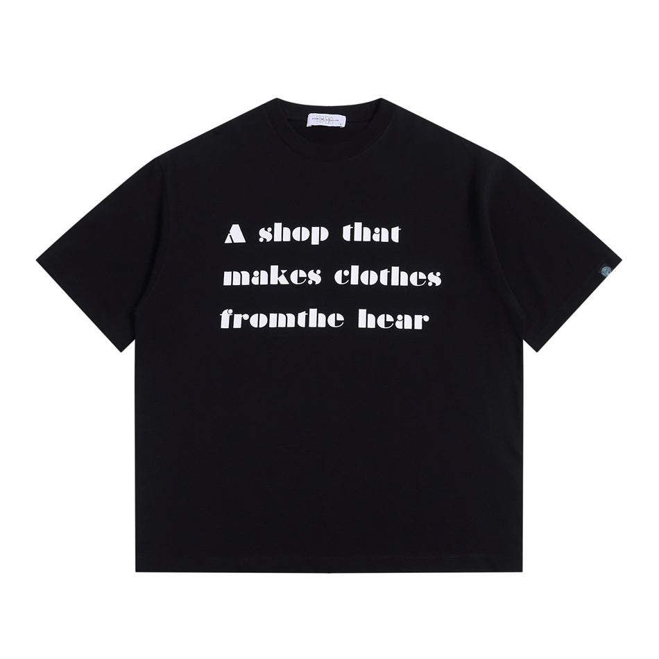 Black short-sleeve crew-neck T-shirt with white block-letter slogan print on the front, flat lay