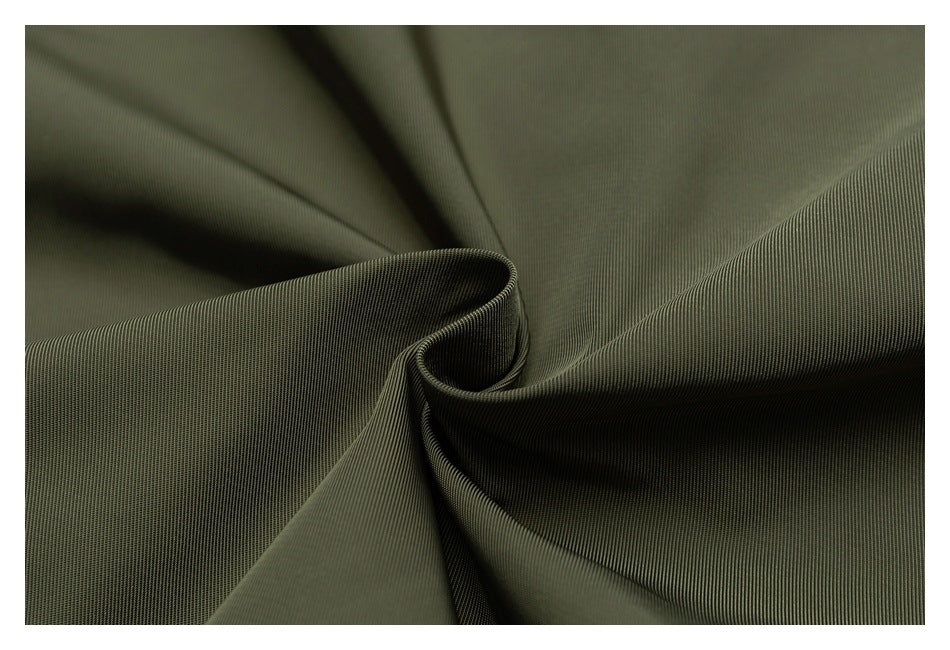 Dark olive fabric gathered into folds, showing a fine, closely spaced ribbed texture.
