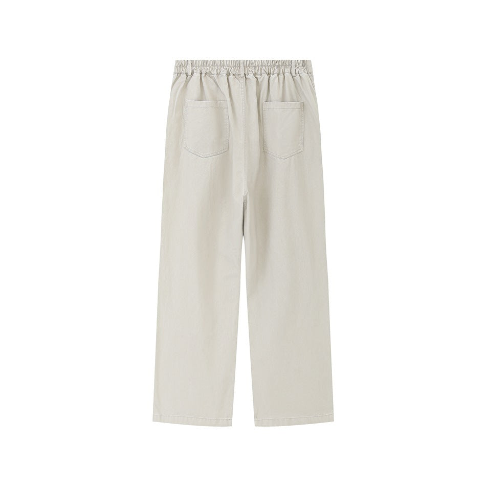 Back view of light khaki wide-leg pants with elastic waistband and two patch pockets