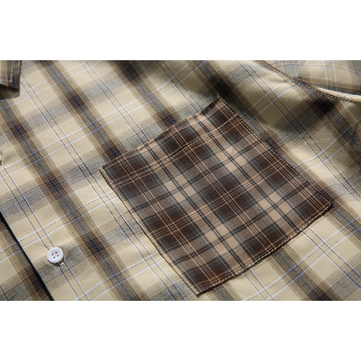 Close-up of the shirt’s brown plaid chest pocket against a tan plaid body.
