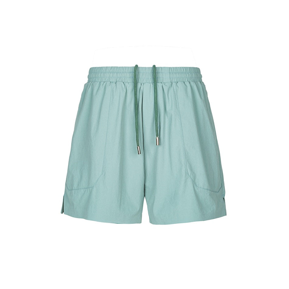 Green drawstring athletic shorts with elastic waistband, front panel seams and side hem slits, flat lay front view