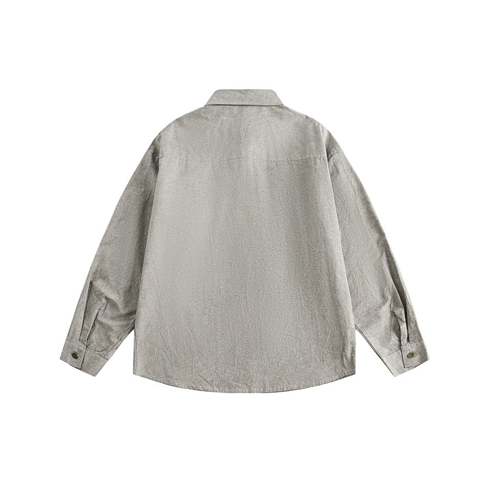 Back view of a light gray long-sleeve shirt with a pointed collar, shoulder yoke, and button cuffs.