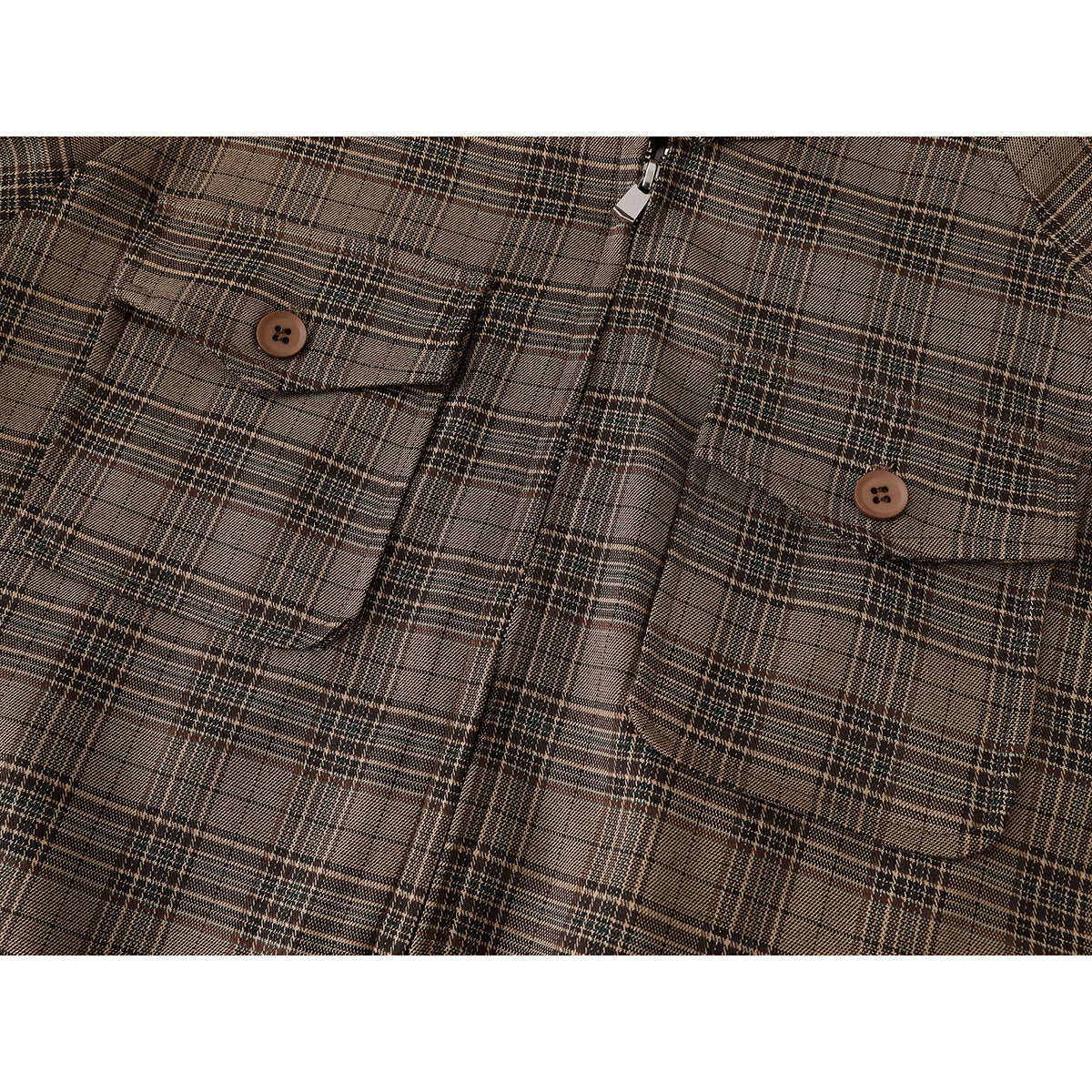 Close-up of the brown plaid jacket's two buttoned chest pockets and center zipper.