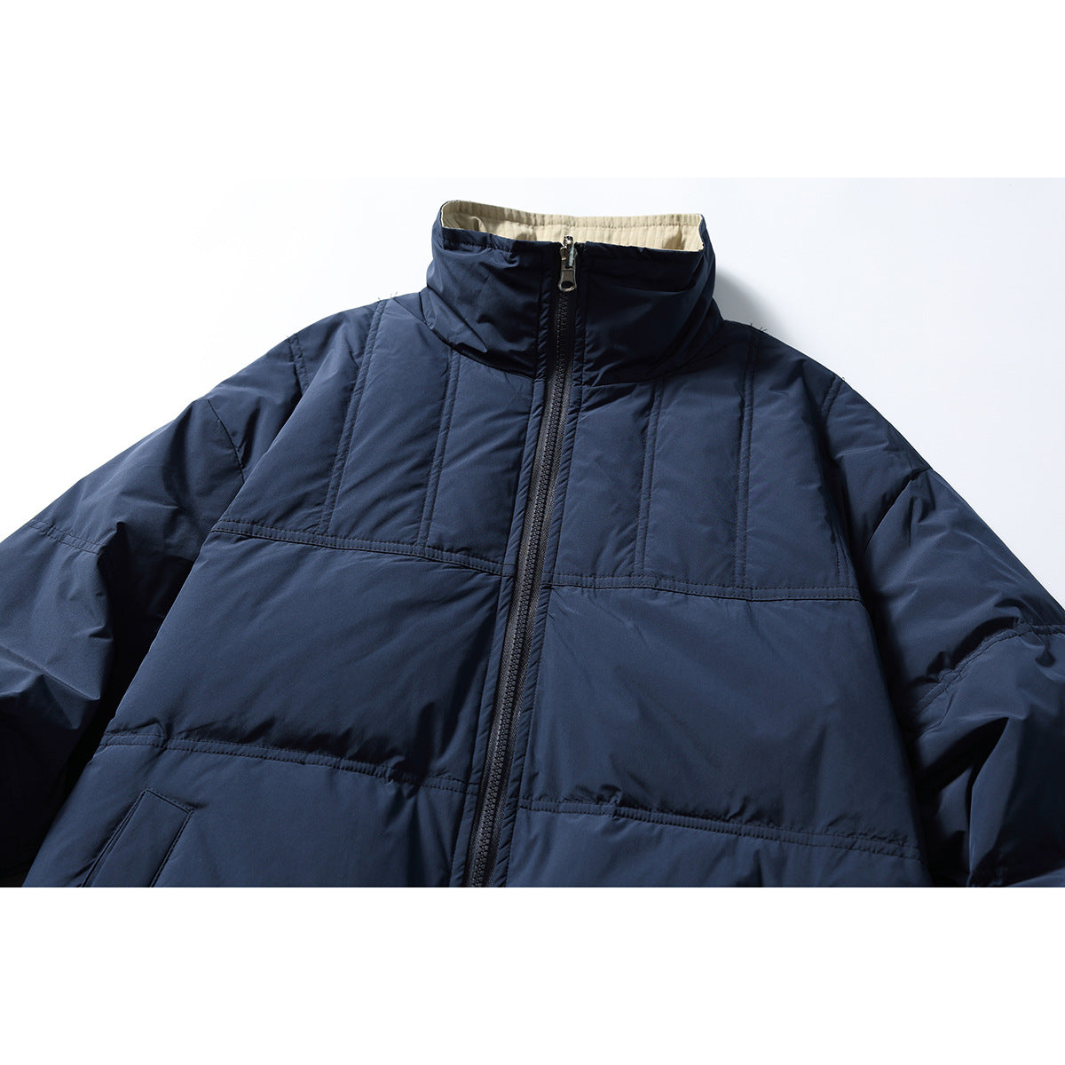 Front view of a navy jacket with a high stand collar, full-length zipper, and horizontal stitched panels.