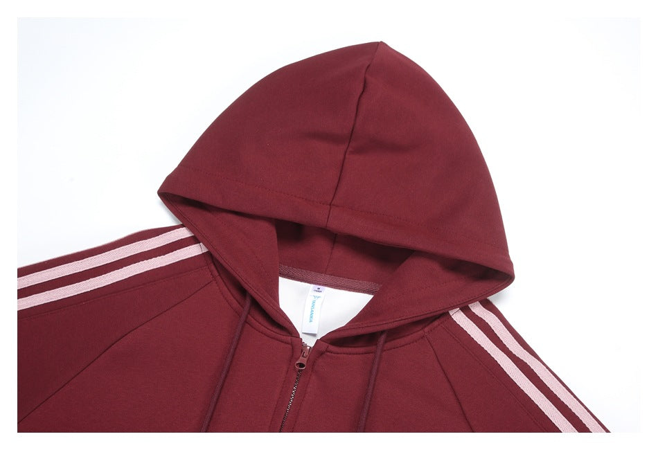 Close-up of the burgundy hoodie’s hood, neckline, zipper and pale shoulder stripes.