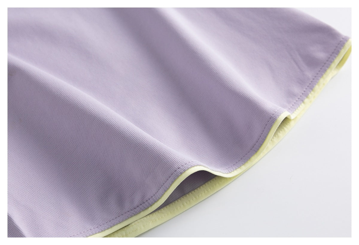 Close-up of a lavender garment hem with pale yellow edge trim and the fabric underside visible.