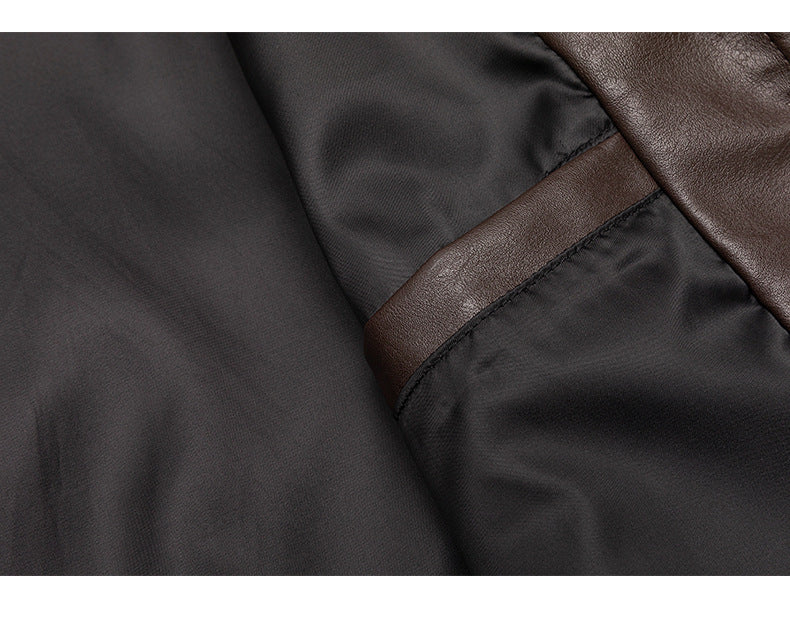 Close-up of dark charcoal fabric with a stitched, textured brown trim.