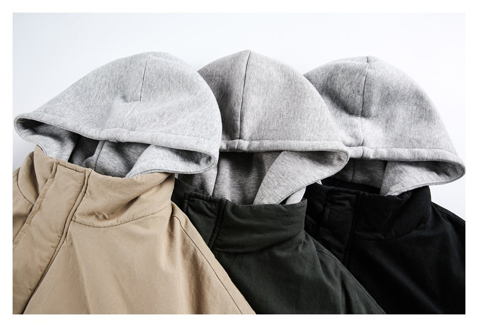 Close-up of three jacket colorways—taupe, dark green, and black—with matching gray hoods.