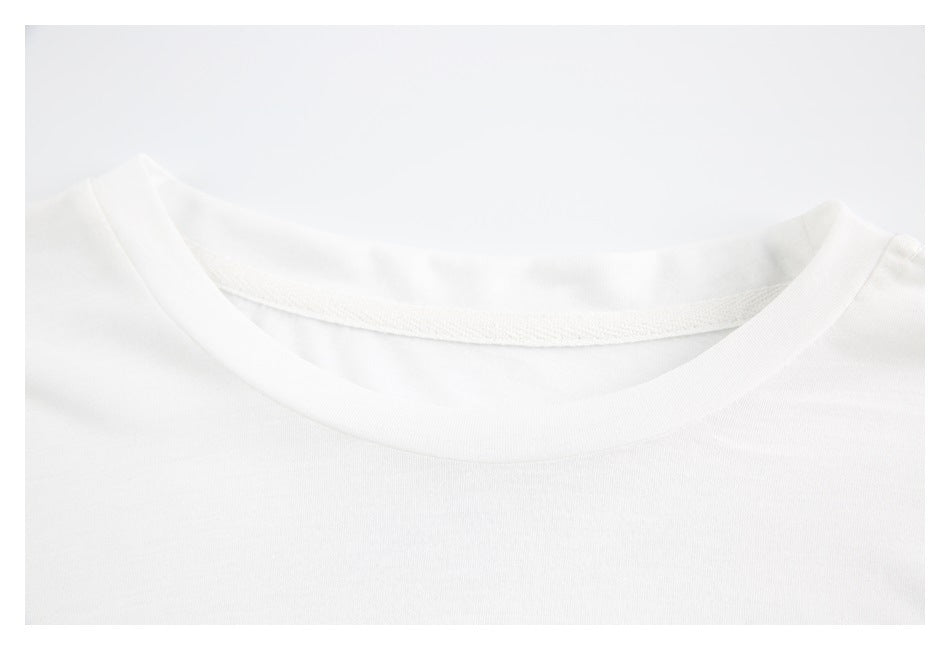 Close-up of the white shirt's rounded crew neckline and inner neck seam.