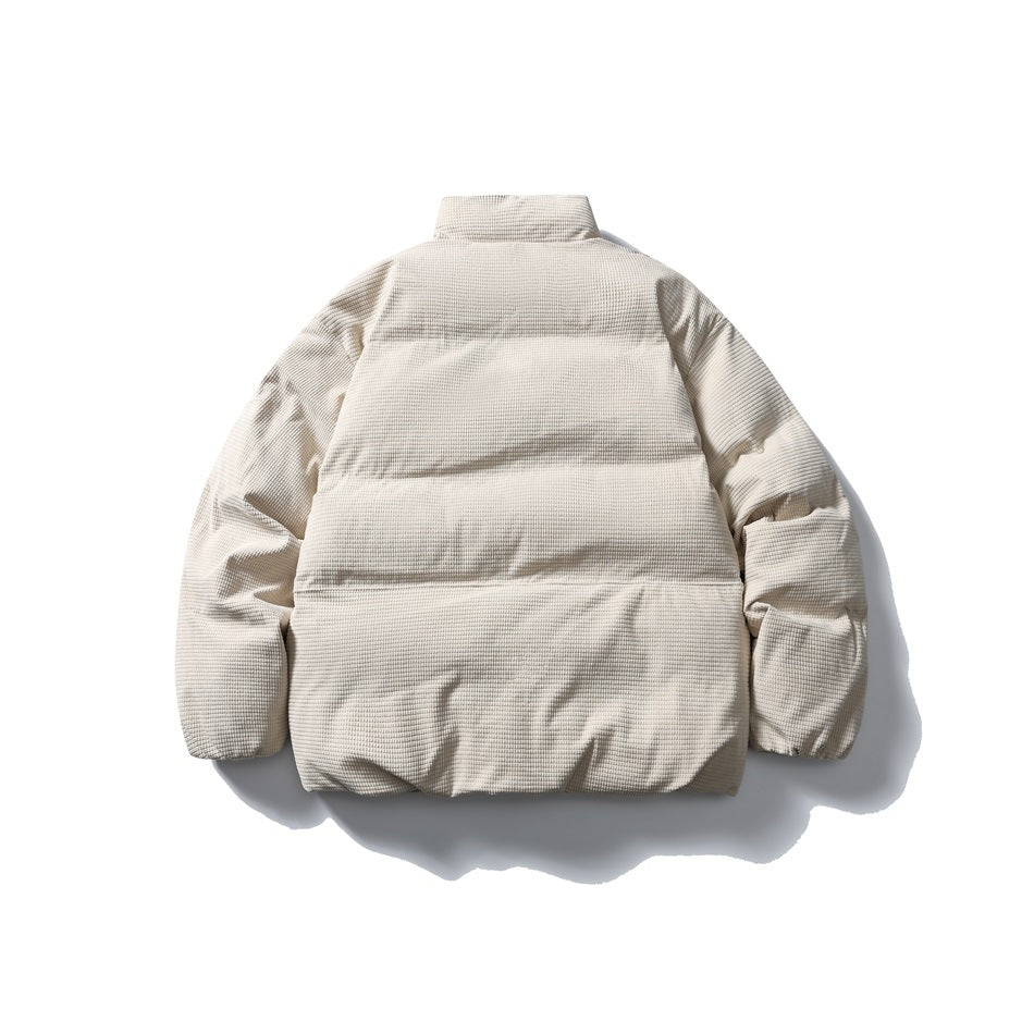 Back view of a cream textured padded jacket laid flat, with a high collar and horizontal quilted sections.