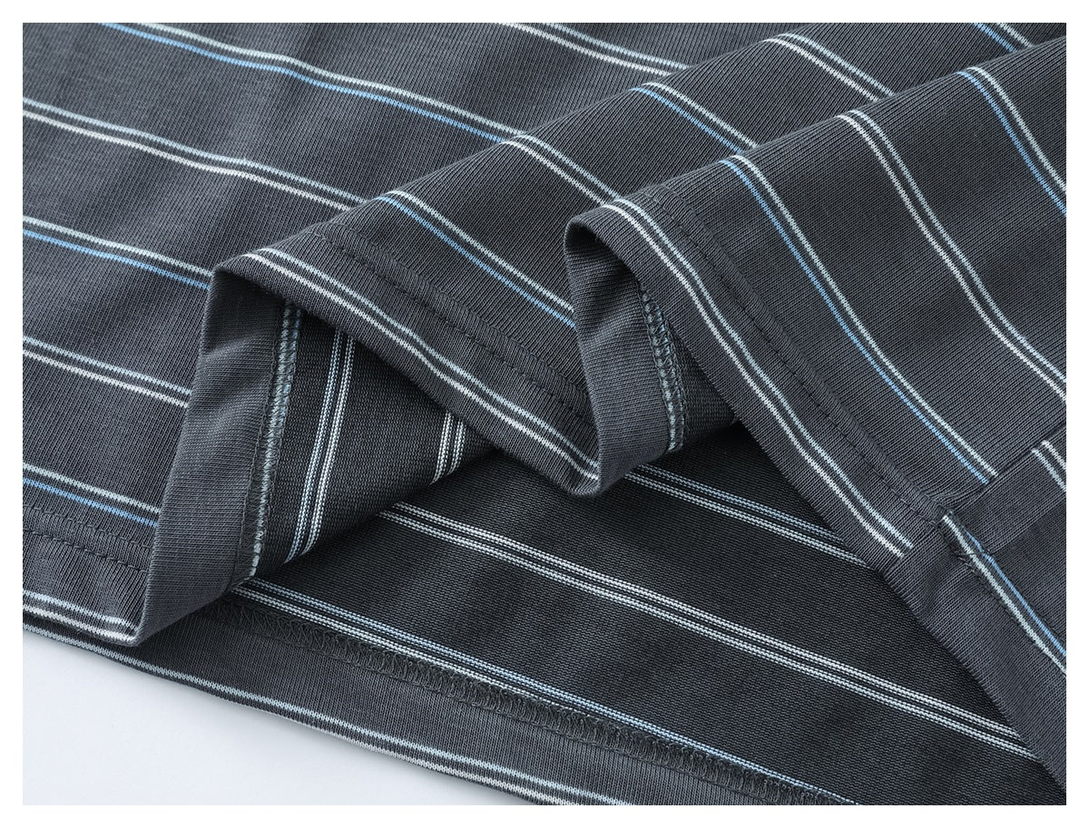 Close-up of the folded hem and interior stitching of a charcoal gray shirt with white and light blue stripes.