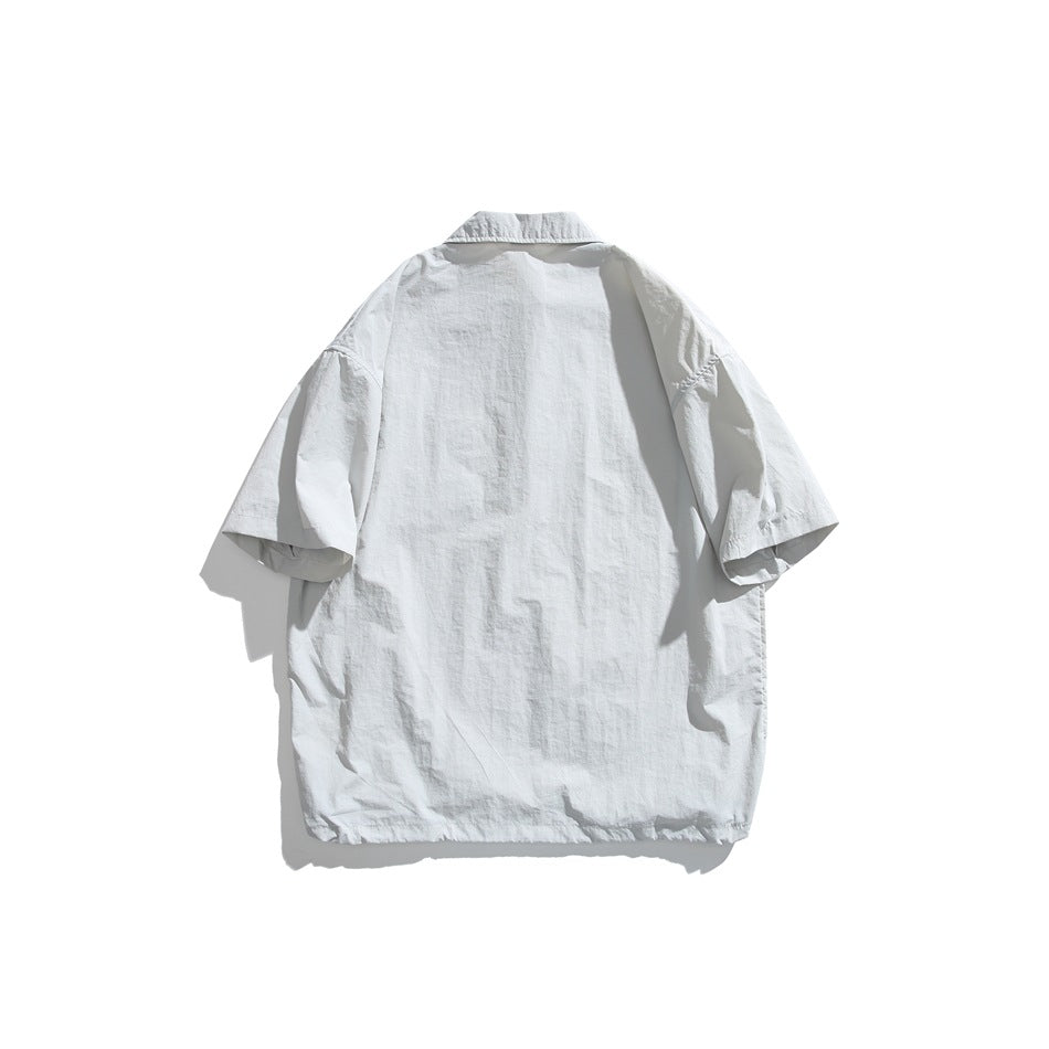 Back view of a pale gray short-sleeve pullover shirt with a pointed collar.