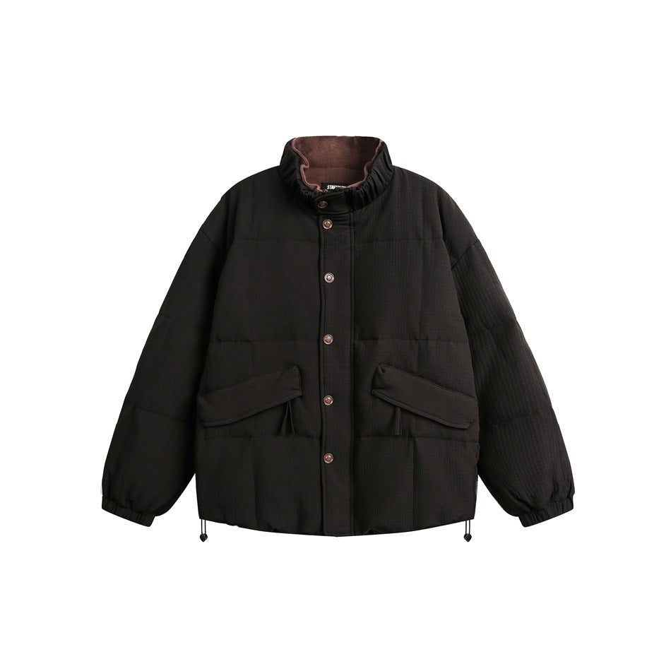 Front view of a black quilted puffer jacket with a high collar, button closure, and flap pockets.