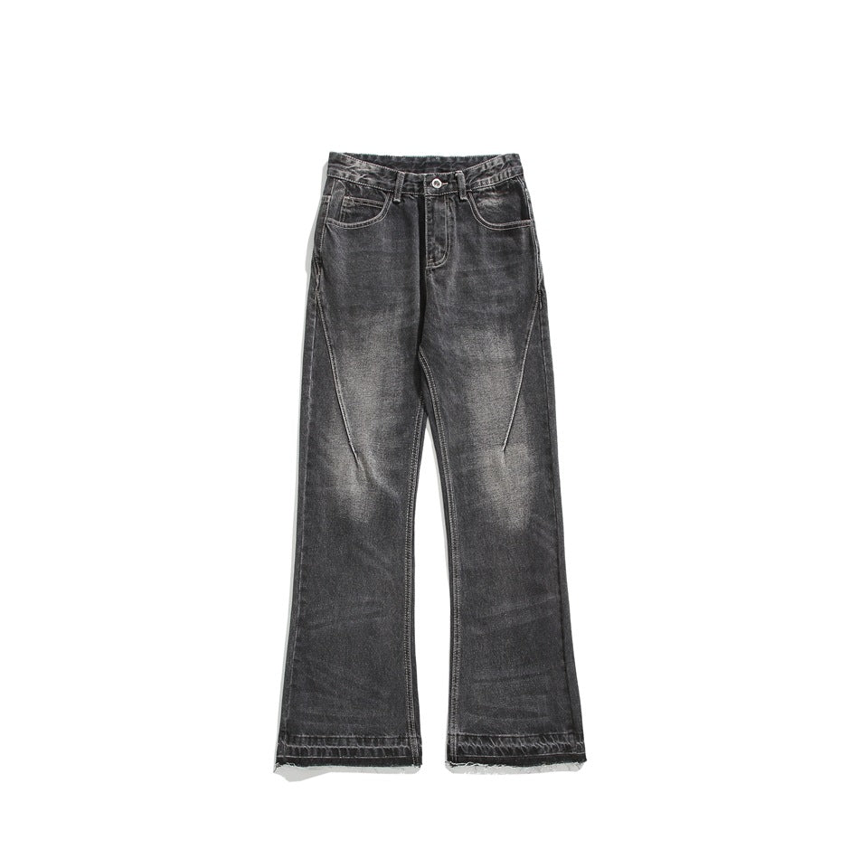 Faded black flared jeans, front flat lay, with whiskering and raw hem