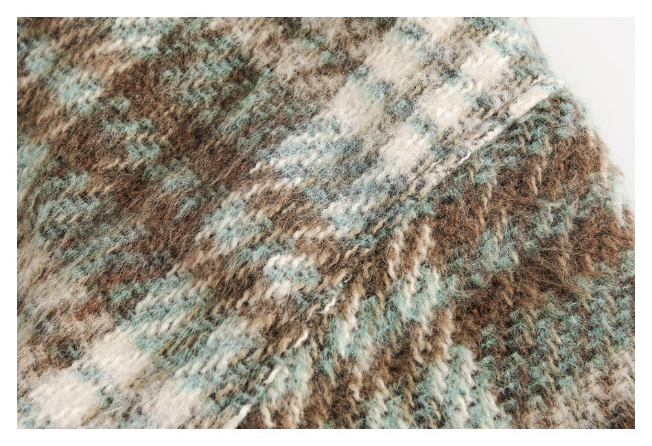 Close-up of the coat's fuzzy, irregular brown, cream, and muted teal pattern.