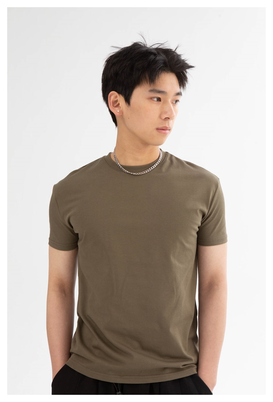 Closer view of a model wearing an olive-brown crew-neck T-shirt.