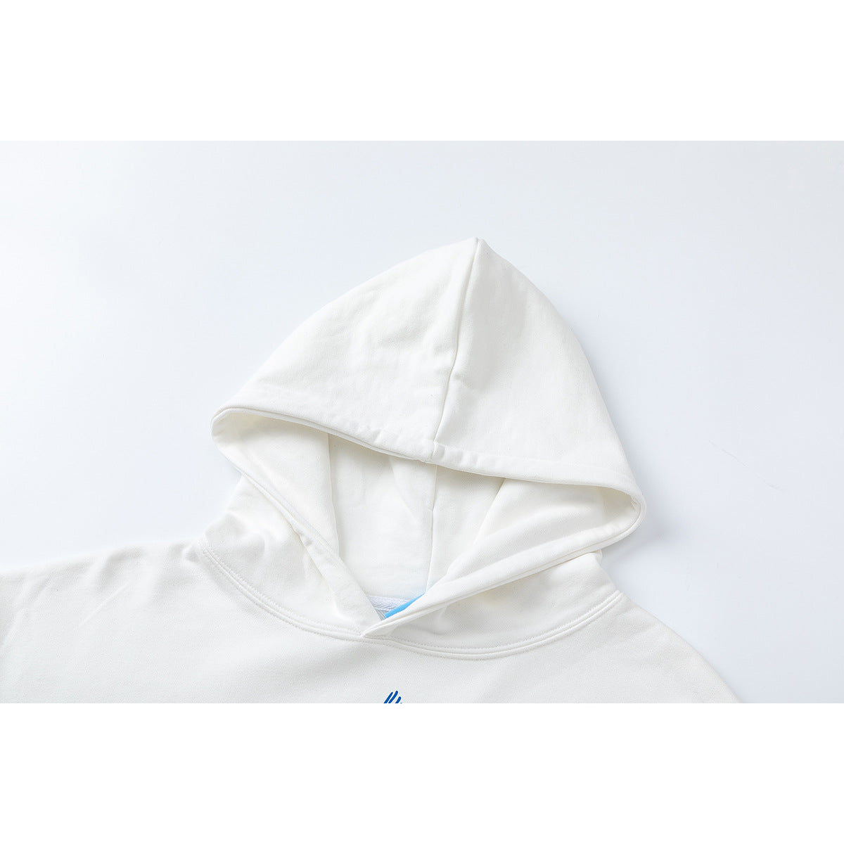 Close-up of the white hoodie’s hood, inner lining, and neckline.