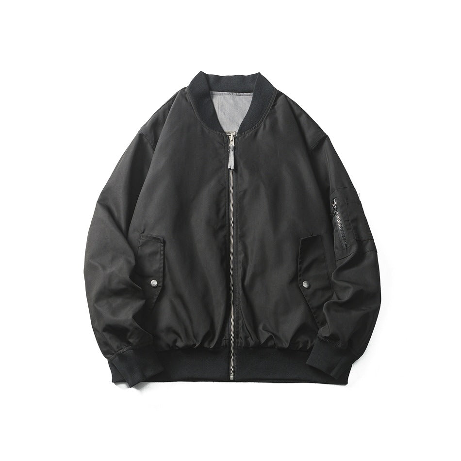 Black bomber jacket shown from the front, with a central zipper, ribbed trim, flap pockets and a zip pocket on one sleeve.