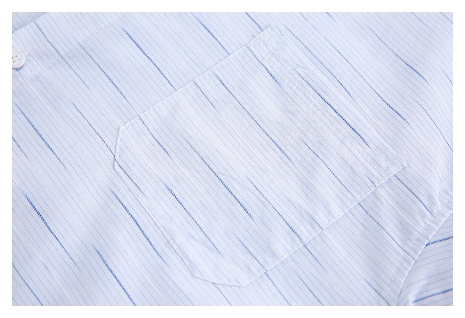 Close-up of the rectangular chest pocket and fine blue stripes on the white shirt.