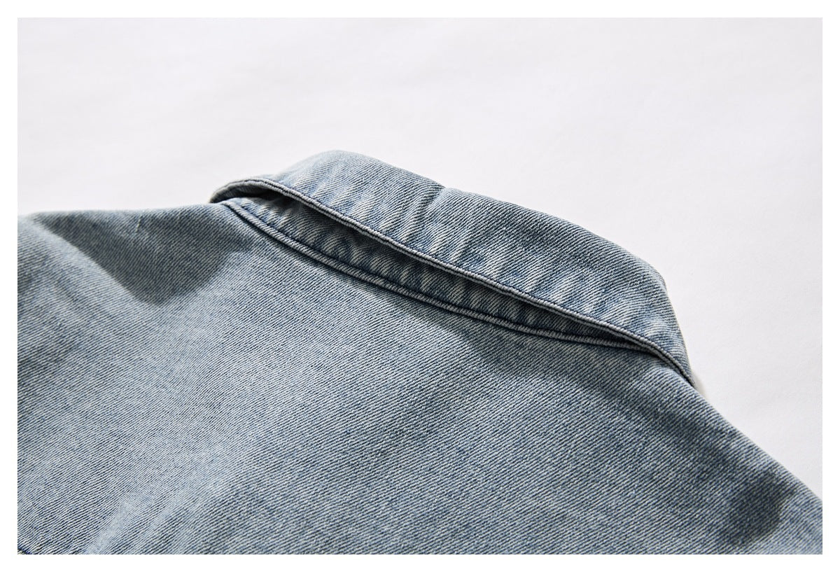 Close-up of a light blue denim garment's collar and upper back.