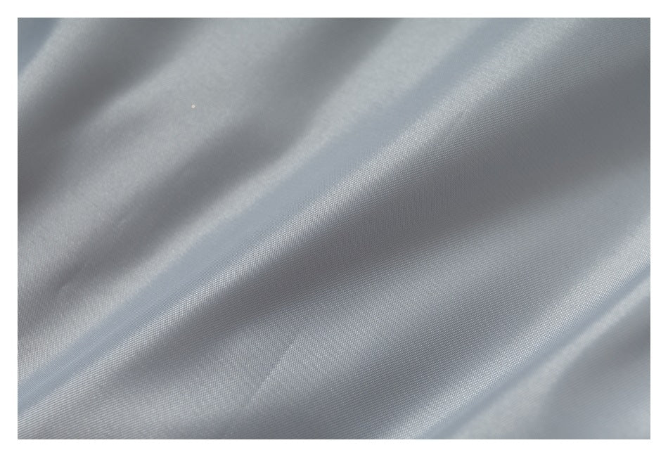 Close-up of light gray fabric showing its fine woven texture.