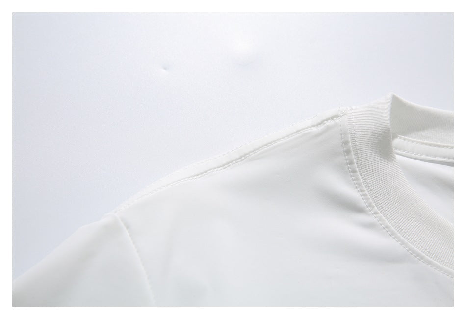 Close-up of a white shirt’s shoulder seam and ribbed crew neckline.