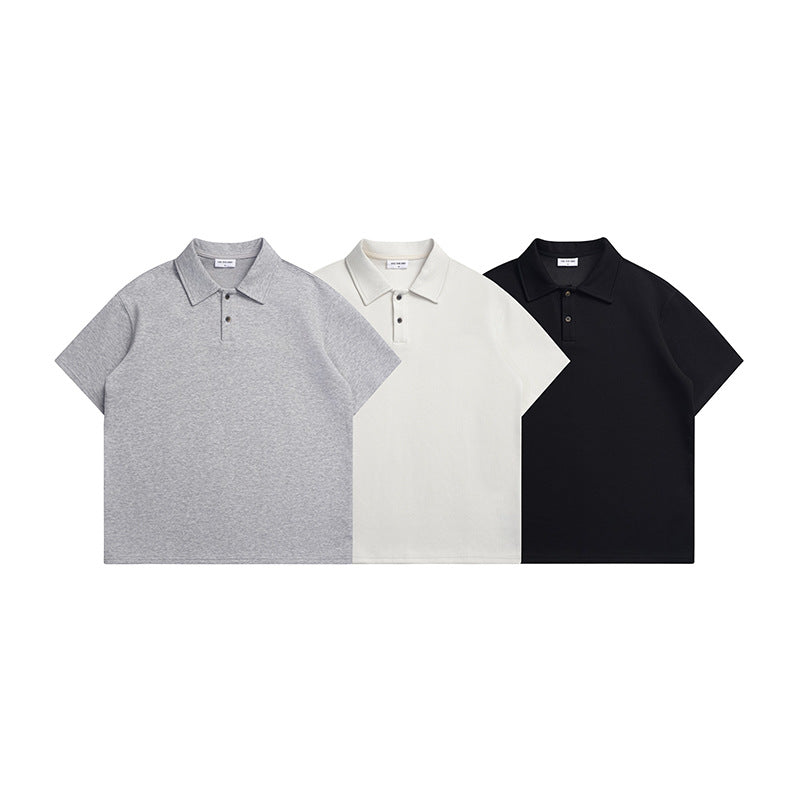 Three short-sleeve polo shirts shown flat in heather gray, off-white and black.