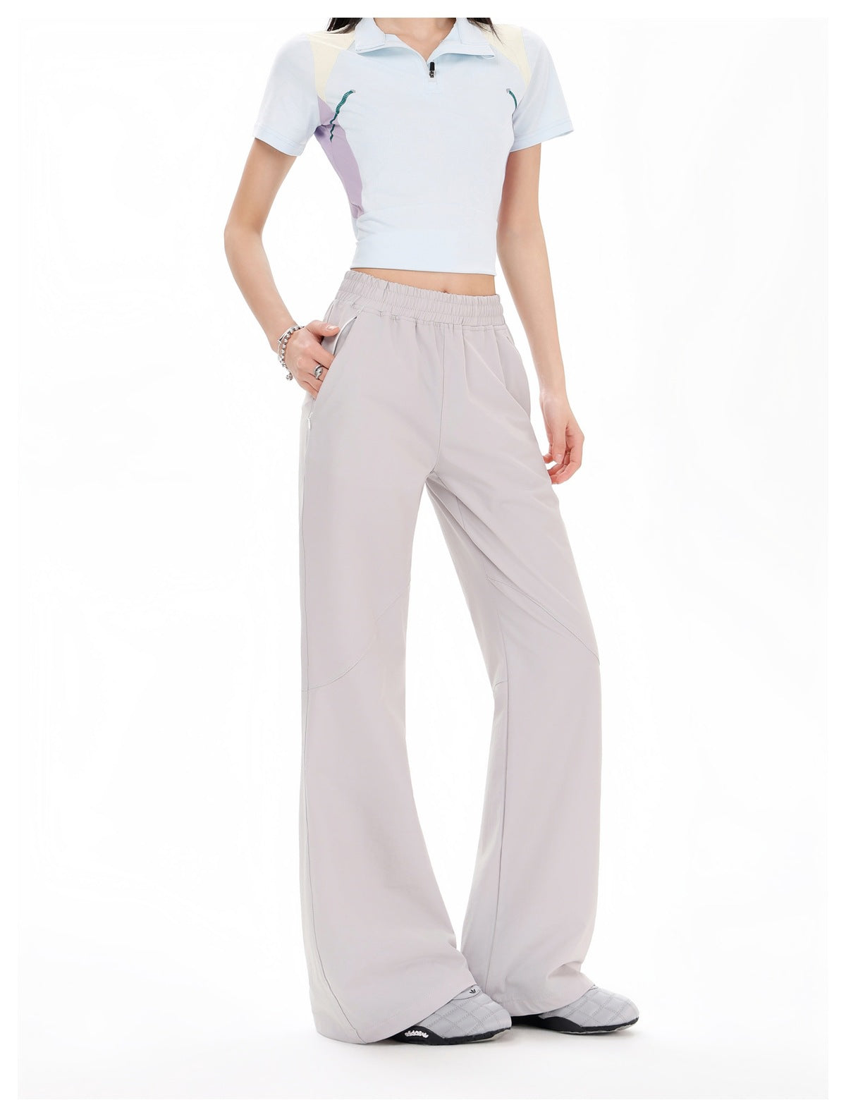 Model wearing pale gray wide-leg pants with an elastic waist, shown from the front, with a cropped light blue top.