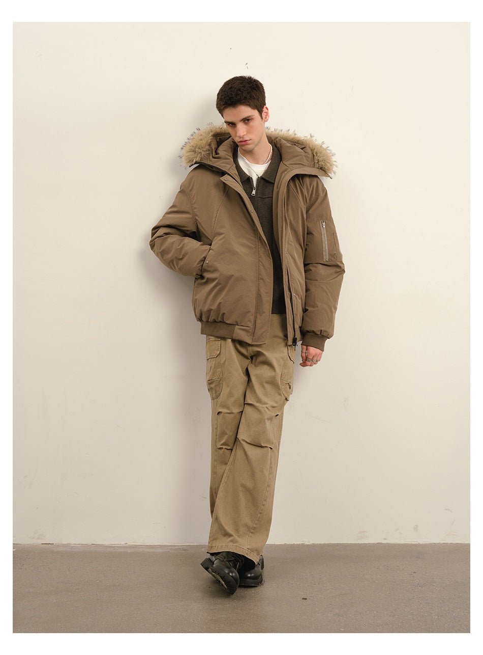 Full-length model wearing an open taupe padded jacket with a fur-trimmed hood, tan cargo trousers, and black boots.